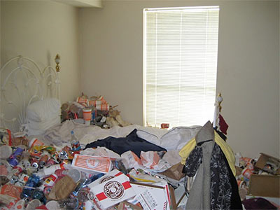 Bedroom of Extremely Messy Apartment in North Houston